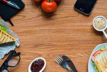 Top view of Healthy Sandwich toast with lettuce, ham, cheese and tomato on a wooden backgroundの写真素材