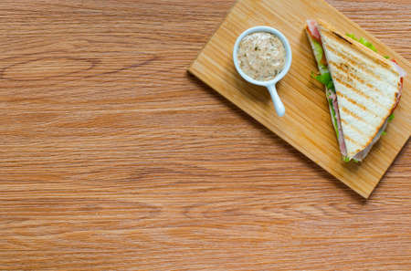 Top view of Healthy Sandwich toast with lettuce, ham, cheese and tomato on a wooden backgroundの写真素材