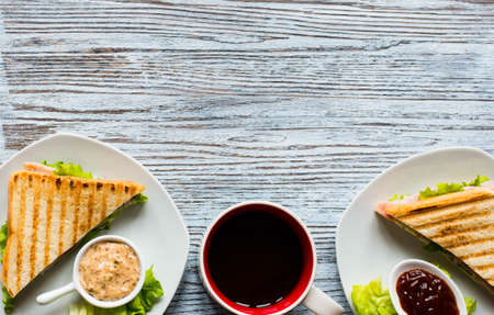 Top view of Healthy Sandwich toast with lettuce, ham, cheese and tomato on a wooden backgroundの写真素材