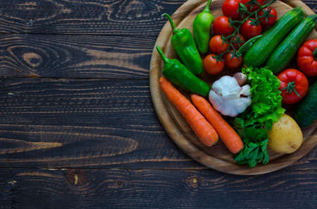 Healthy food and copy space, fresh vegetables, organic on a wooden backgroundの写真素材