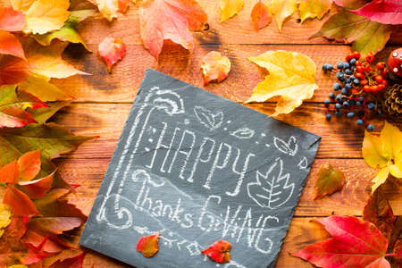 Thanksgiving day, autumn leaves background and text, on different rustic woodenの写真素材