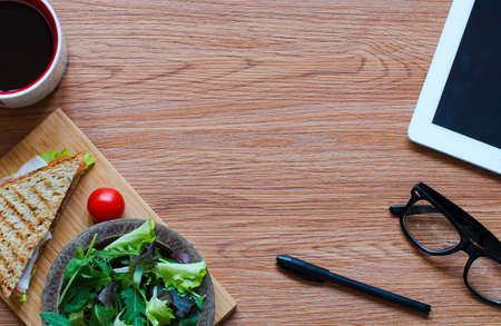 Top view of Healthy Sandwich toast with lettuce, ham, cheese and tomato on a wooden backgroundの写真素材