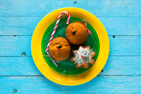 Mini panettone with fruits and Christmas decoration, on different wood backgroundの写真素材