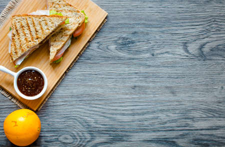 Top view of Healthy Sandwich toast with lettuce, ham, cheese and tomato on a wooden backgroundの写真素材