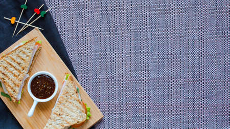 Top view of Healthy Sandwich toast with lettuce, ham, cheese and tomato on a wooden backgroundの写真素材