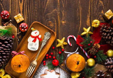 Mini panettone with fruits and Christmas decoration, on different wood backgroundの写真素材