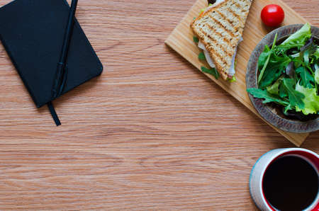 Top view of Healthy Sandwich toast with lettuce, ham, cheese and tomato on a wooden backgroundの写真素材