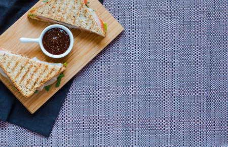 Top view of Healthy Sandwich toast with lettuce, ham, cheese and tomato on a wooden backgroundの写真素材