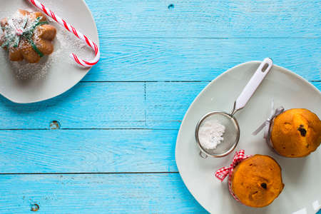 Mini panettone with fruits and Christmas decoration, on different wood backgroundの写真素材