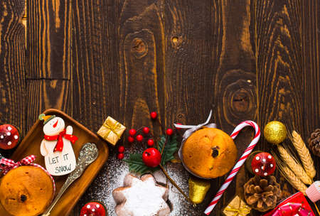 Mini panettone with fruits and Christmas decoration, on different wood backgroundの写真素材