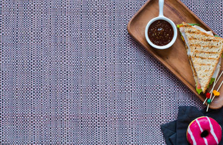 Top view of Healthy Sandwich toast with lettuce, ham, cheese and tomato on a wooden backgroundの写真素材