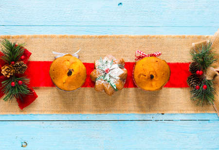 Mini panettone with fruits and Christmas decoration, on different wood backgroundの写真素材
