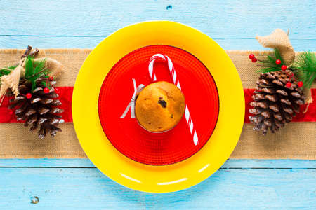 Mini panettone with fruits and Christmas decoration, on different wood backgroundの写真素材