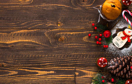 Mini panettone with fruits and Christmas decoration, on different wood backgroundの写真素材