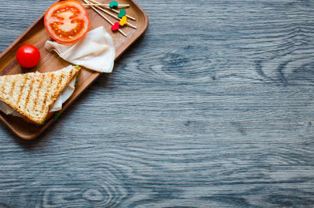 Top view of Healthy Sandwich toast with lettuce, ham, cheese and tomato on a wooden backgroundの写真素材