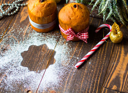 Mini panettone with fruits and Christmas decoration, on different wood backgroundの写真素材