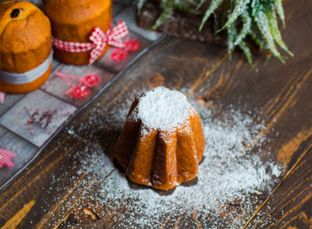 Mini pandoro with Christmas decoration, on wooden backgroundの写真素材
