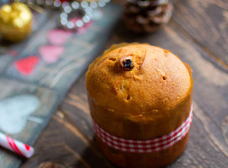 Mini panettone with fruits and Christmas decoration, on different wood backgroundの写真素材