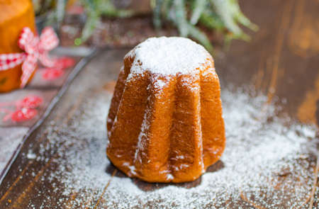 Mini pandoro with Christmas decoration, on wooden backgroundの写真素材