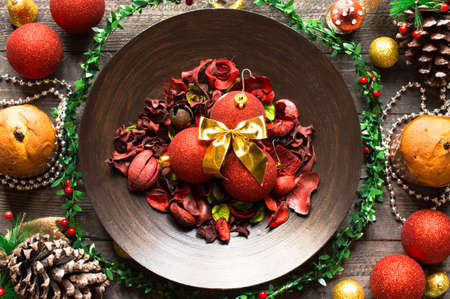 Mini panettone with fruits and Christmas decoration, on different wood backgroundの写真素材
