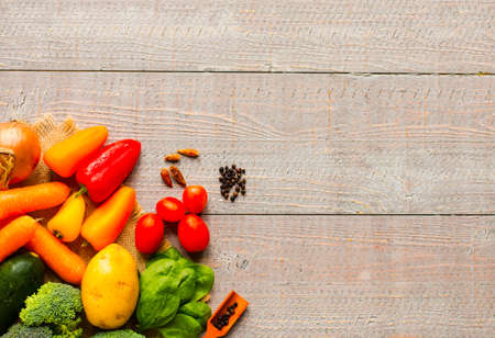 Healthy food and copy space, fresh vegetables, organic on a wooden backgroundの写真素材