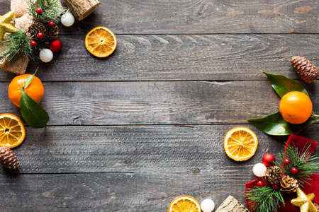 Christmas holiday background with ornaments like cookies and oranges on rustic wooden background.の写真素材