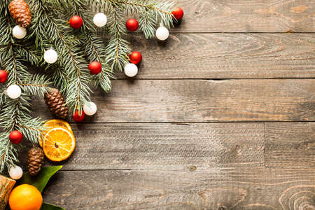 Christmas holiday background with ornaments like cookies and oranges on rustic wooden background.の写真素材