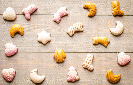 Christmas holiday background with ornaments like cookies and oranges on rustic wooden background.の写真素材