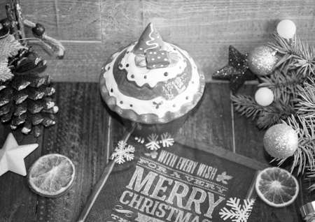 Christmas decoration, ceramic sledding,baubles and oranges on a rustic wooden backgroundの写真素材