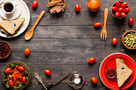Top view of Healthy Sandwich toast with lettuce, ham, cheese, tomato and coffee, on a wooden backgroundの写真素材