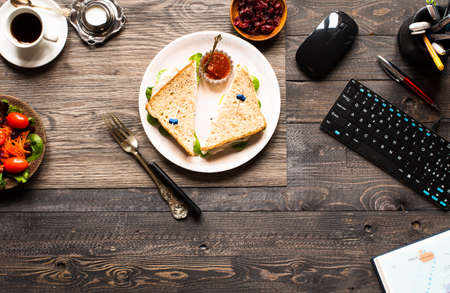 Top view of Healthy Sandwich toast with lettuce, ham, cheese, tomato and coffee, on a wooden backgroundの写真素材