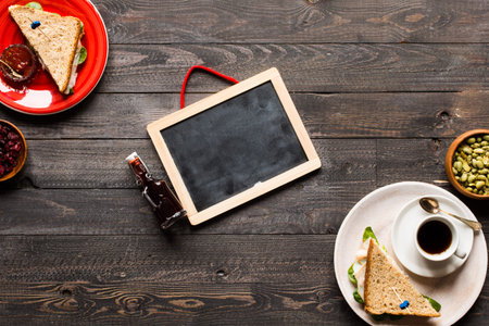 Top view of Healthy Sandwich toast with lettuce, ham, cheese, tomato and coffee, on a wooden...