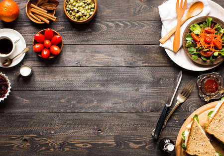 Top view of Healthy Sandwich toast with lettuce, ham, cheese, tomato and coffee, on a wooden backgroundの写真素材