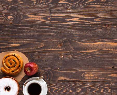 Top view of Healthy Sandwich toast with coffee,donuts, with fruits on a wooden backgroundの写真素材