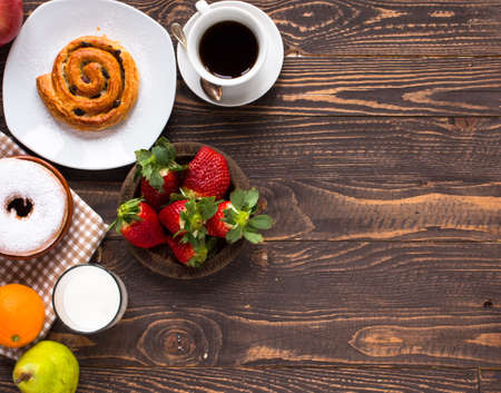 Top view of Healthy Sandwich toast with coffee,donuts, with fruits on a wooden backgroundの写真素材