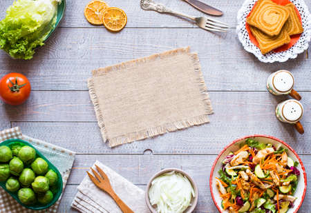Salad of chicken breast with zucchini and cherry tomatoes, on a wooden background. top viewの写真素材