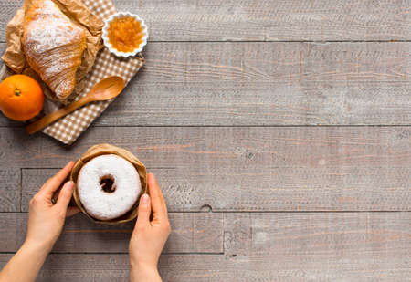 Coffee and croissant for breakfast, on rustic wooden table, top viewの写真素材