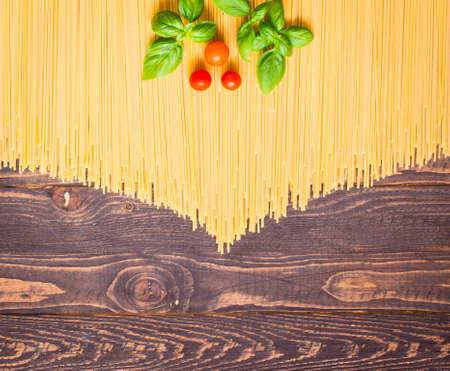 Close-up of decorating Italian pasta. Concept of traditional cuisine and healthy meal. On a wooden backgroundの写真素材