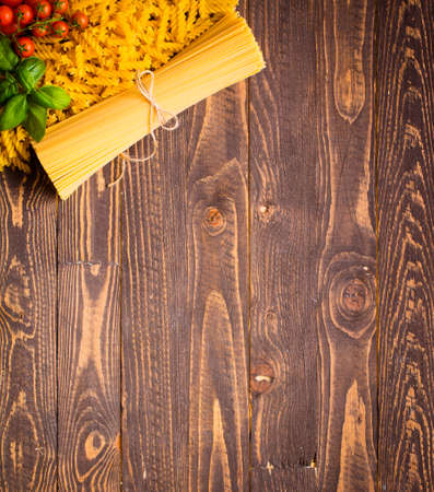 Close-up of decorating Italian pasta. Concept of traditional cuisine and healthy meal. On a wooden backgroundの写真素材