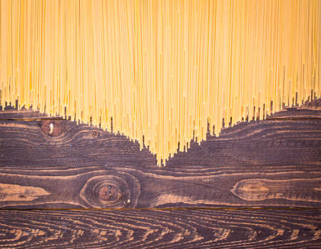 Close-up of decorating Italian pasta. Concept of traditional cuisine and healthy meal. On a wooden backgroundの写真素材