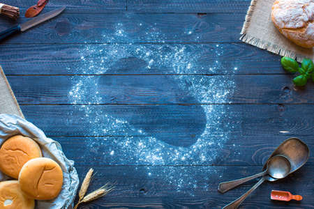 Fresh homemade bread, on wooden background. Top viewの写真素材