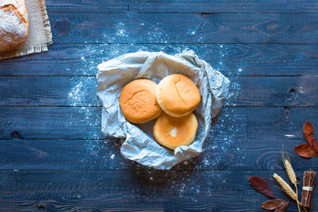 Fresh homemade bread, on wooden background. Top viewの写真素材