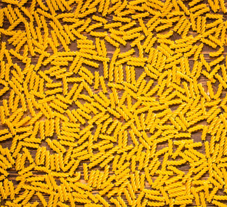 Close-up of decorating Italian pasta. Concept of traditional cuisine and healthy meal. On a wooden backgroundの写真素材