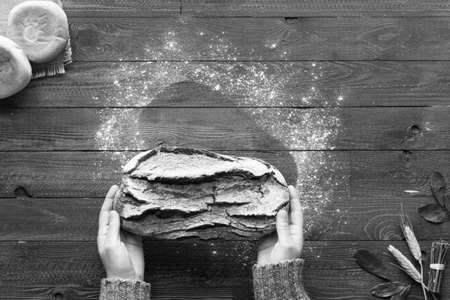 Fresh homemade bread, on wooden background. Top viewの写真素材