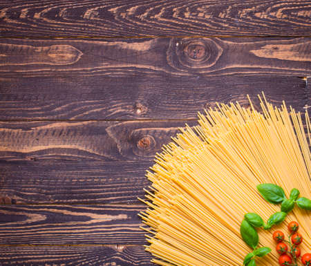Close-up of decorating Italian pasta. Concept of traditional cuisine and healthy meal. On a wooden backgroundの写真素材