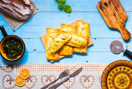 Delicious pie with spinach, made at home, on a wooden background, top viewの写真素材