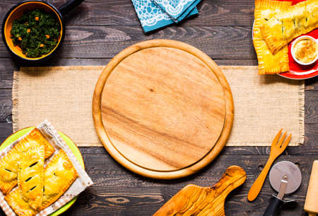 Delicious pie with spinach, made at home, on a wooden background, top viewの写真素材