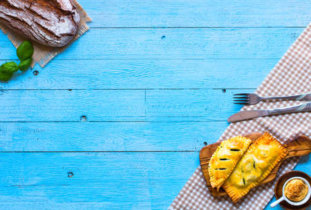 Delicious pie with spinach, made at home, on a wooden background, top viewの写真素材