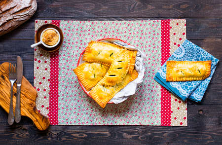 Delicious pie with spinach, made at home, on a wooden background, top viewの写真素材