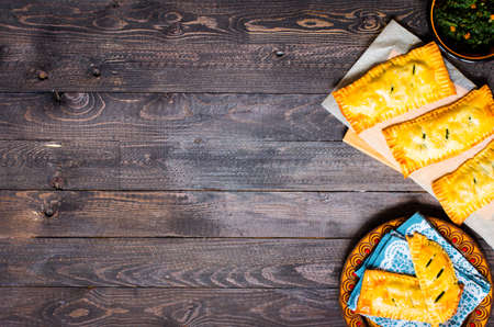 Delicious pie with spinach, made at home, on a wooden background, top viewの写真素材